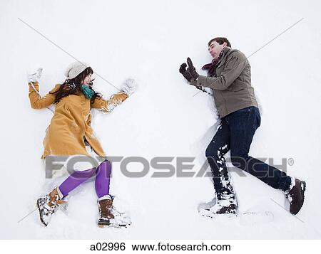 USA, Utah, Orem, young couple lying in snow View Large Photo Image Stock Photograph - USA, Utah, Orem, young couple lying in snow. Fotosearch