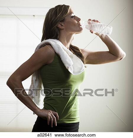 USA, Utah, Orem, young woman drinking water after exercising View Large Photo Image Stock Image - USA, Utah, Orem, young woman drinking water after exercising. Fotosearch