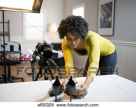 Stock Photography - USA, Utah, Orem, Young woman preparing high heels for photograph. Fotosearch
