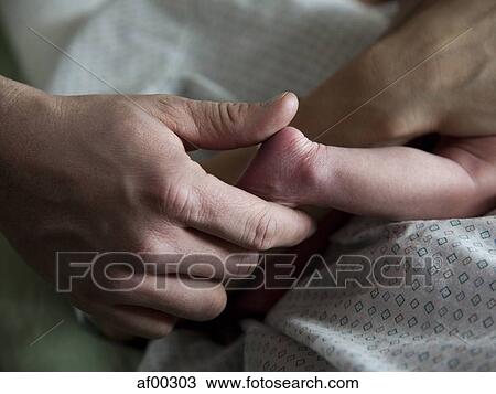 USA, Utah, Payson, Close-up of hand holding newborn's foot View Large Photo Image Stock Image - USA, Utah, Payson, Close-up of hand holding newborn's foot. Fotosearch