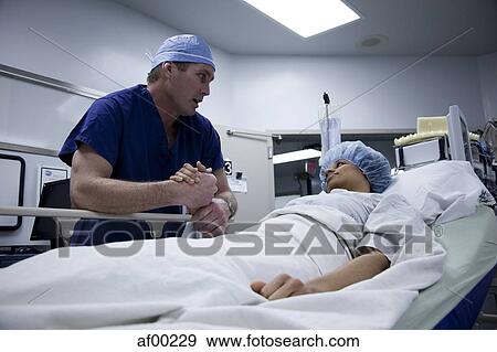 USA, Utah, Payson, Doctor talking to patient before operation View Large Photo Image Stock Photo - USA, Utah, Payson, Doctor talking to patient before operation. Fotosearch