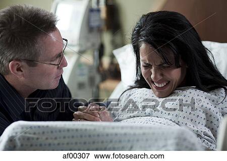 USA, Utah, Payson, Man watching wife giving birth View Large Photo Image Stock Photo - USA, Utah, Payson, Man watching wife giving birth. Fotosearch
