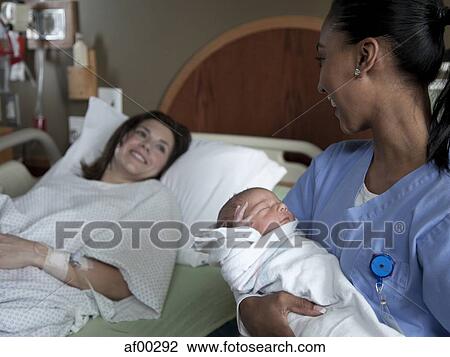 USA, Utah, Payson, Nurse holding newborn boy View Large Photo Image Stock Image - USA, Utah, Payson, Nurse holding newborn boy. Fotosearch