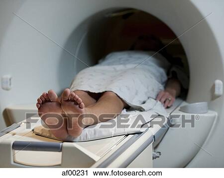 Stock Image - USA, Utah, Payson, Young woman during Magnetic Resonance Imaging . Fotosearch