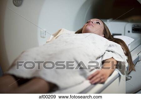 Stock Photo - USA, Utah, Payson, Young woman during Magnetic Resonance Imaging . Fotosearch
