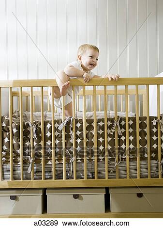 USA, Utah, Provo, baby boy (18-23 months) standing in crib View Large Photo Image Stock Photo - USA, Utah, Provo, baby boy (18-23 months) standing in crib. Fotosearch
