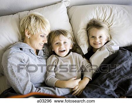 USA, Utah, Provo, Boy and girl (2-5) in bed with mother View Large Photo Image Stock Photograph - USA, Utah, Provo, Boy and girl (2-5) in bed with mother. Fotosearch