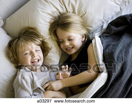 USA, Utah, Provo, Brother and sister (2-5) lying in bed View Large Photo Image Stock Photo - USA, Utah, Provo, Brother and sister (2-5) lying in bed. Fotosearch
