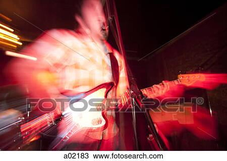 Stock Image - USA, Utah, Provo, man playing electric guitar. Fotosearch