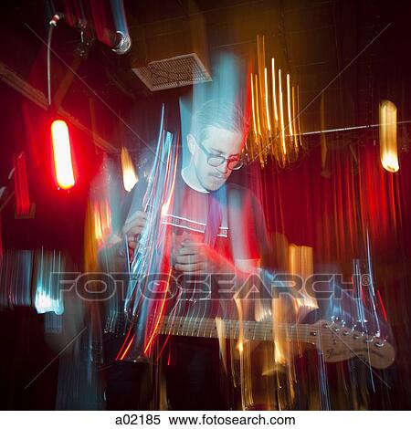 Stock Photography - USA, Utah, Provo, man playing electric guitar. Fotosearch