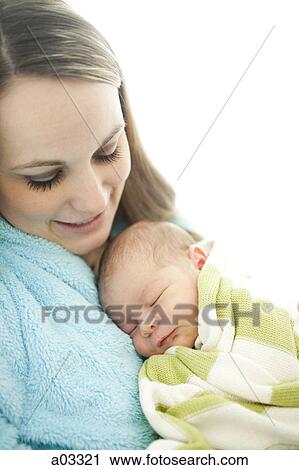Stock Image - USA, Utah, Provo, Mother embracing baby boy (0-1 months). Fotosearch