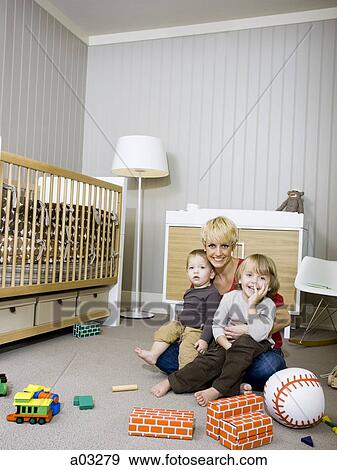 USA, Utah, Provo, Mother embracing two boys in games room View Large Photo Image Stock Photo - USA, Utah, Provo, Mother embracing two boys in games room. Fotosearch