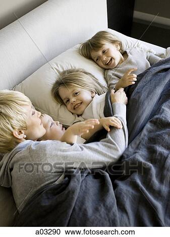 USA, Utah, Provo, Mother in bed with children (18-23 months), (2-5) View Large Photo Image Stock Image - USA, Utah, Provo, Mother in bed with children (18-23 months), (2-5). Fotosearch