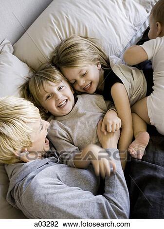 USA, Utah, Provo, Mother in bed with children (18-23 months), (2-5) View Large Photo Image Stock Image - USA, Utah, Provo, Mother in bed with children (18-23 months), (2-5). Fotosearch