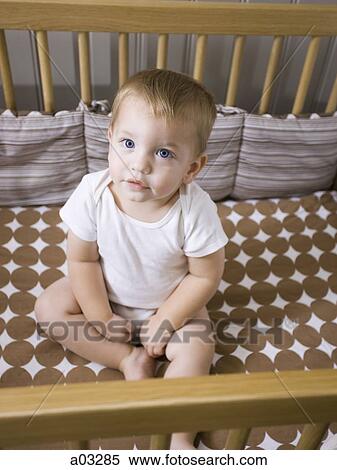 USA, Utah, Provo, Portrait of baby boy (18-23 months) sitting in crib View Large Photo Image Stock Photography - USA, Utah, Provo, Portrait of baby boy (18-23 months) sitting in crib. Fotosearch