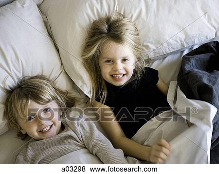 USA, Utah, Provo, Portrait of brother and sister (2-5) lying in bed View Large Photo Image Stock Photo - USA, Utah, Provo, Portrait of brother and sister (2-5) lying in bed. Fotosearch