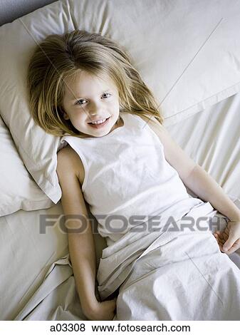 USA, Utah, Provo, Portrait of girl (4-5) lying in bed View Large Photo Image Stock Photo - USA, Utah, Provo, Portrait of girl (4-5) lying in bed. Fotosearch