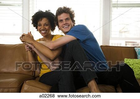 USA, Utah, Provo, young couple fighting over the TV remote View Large Photo Image Stock Photo - USA, Utah, Provo, young couple fighting over the TV remote. Fotosearch