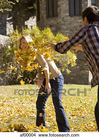Picture - USA, Utah, Provo, Young couple having fun in park. Fotosearch