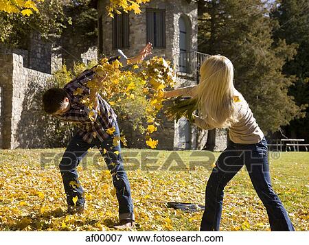 Stock Photo - USA, Utah, Provo, Young couple having fun in park. Fotosearch