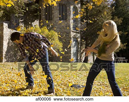 Stock Photograph - USA, Utah, Provo, Young couple having fun in park. Fotosearch