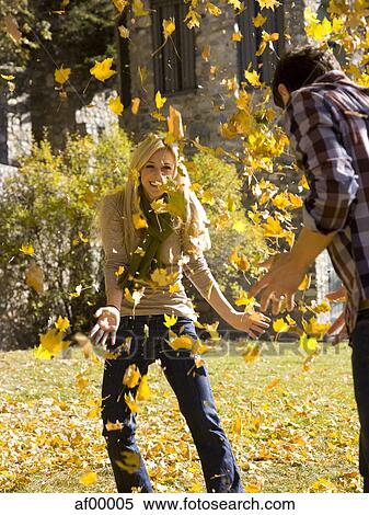 Stock Photography - USA, Utah, Provo, Young couple having fun in park. Fotosearch