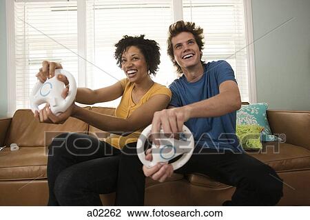USA, Utah, Provo, young couple playing video games in living room View Large Photo Image Stock Image - USA, Utah, Provo, young couple playing video games in living room. Fotosearch