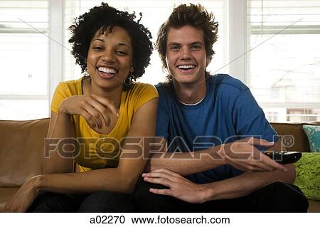 USA, Utah, Provo, young couple watching television in living room View Large Photo Image Stock Image - USA, Utah, Provo, young couple watching television in living room. Fotosearch