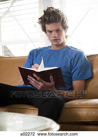 USA, Utah, Provo, young man reading book on sofa View Large Photo Image Stock Image - USA, Utah, Provo, young man reading book on sofa. Fotosearch