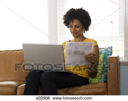 USA, Utah, Provo, young woman using laptop on couch View Large Photo Image Stock Photograph - USA, Utah, Provo, young woman using laptop on couch. Fotosearch
