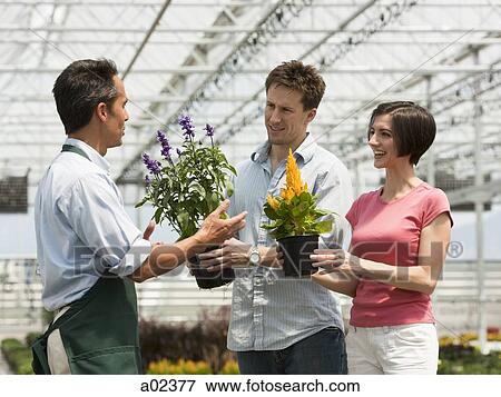 Stock Photo - USA, Utah, Salem, couple buying flowers from gardener. Fotosearch