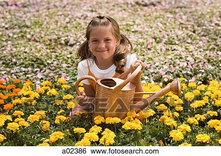 Stock Photograph - USA, Utah, Salem, portrait of girl (8-9) in flower field. Fotosearch