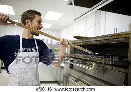 Stock Photograph - USA, Utah, Salt Lake City, Chef working in bakery. Fotosearch