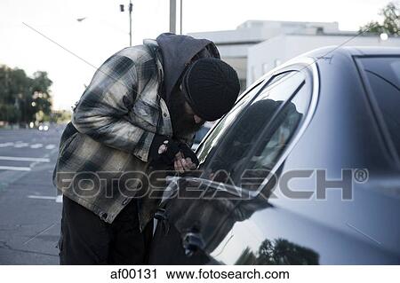 USA, Utah, Salt Lake City, Homeless man breaking into car, side view View Large Photo Image Stock Image - USA, Utah, Salt Lake City, Homeless man breaking into car, side view. Fotosearch