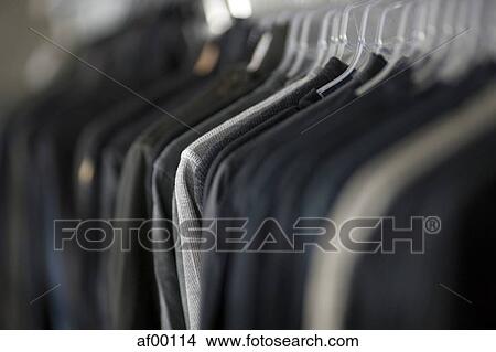 Picture - USA, Utah, Salt Lake City, Suits hanging on rail. Fotosearch