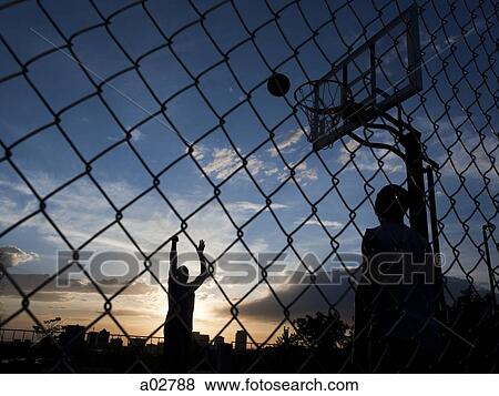 USA, Utah, Salt Lake City, two young men playing street basketball View Large Photo Image Stock Photo - USA, Utah, Salt Lake City, two young men playing street basketball. Fotosearch