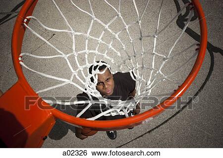 USA, Utah, Salt Lake City, young man looking up at basketball hoop View Large Photo Image Stock Photograph - USA, Utah, Salt Lake City, young man looking up at basketball hoop. Fotosearch