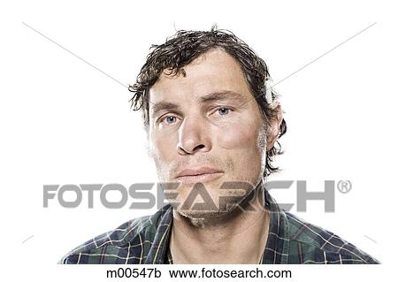 Stock Image - White trash man with a cigarette behind his ear. Fotosearch