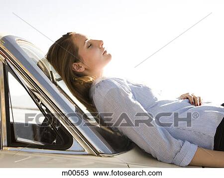 woman asleep on the hood of her car View Large Photo Image Stock Image - woman asleep on the hood of her car. Fotosearch