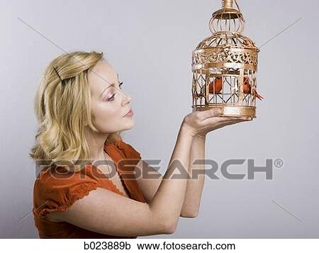 woman holding a birdcage View Large Photo Image Stock Image - woman holding a birdcage. Fotosearch