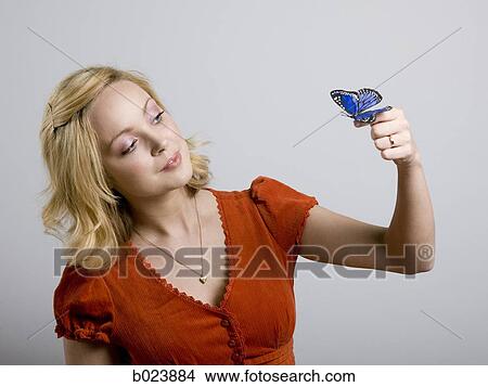 Picture - woman holding a butterfly. Fotosearch