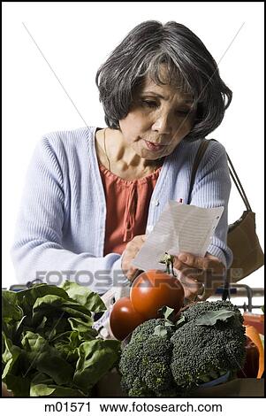 woman looking at a shopping list View Large Photo Image Stock Image - woman looking at a shopping list. Fotosearch