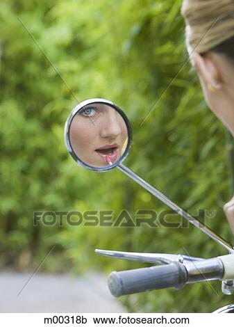 woman looking at camera in her rearview mirror View Large Photo Image Stock Image - woman looking at camera in her rearview mirror. Fotosearch