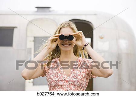 woman looking through binoculars View Large Photo Image Picture - woman looking through binoculars. Fotosearch