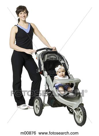 woman pushing her baby in a stroller View Large Photo Image Stock Photograph - woman pushing her baby in a stroller. Fotosearch