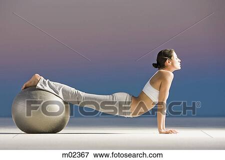 woman rolling on a swiss ball View Large Photo Image Stock Photo - woman rolling on a swiss ball. Fotosearch