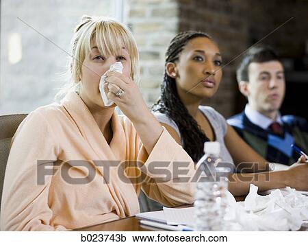 Stock Image - woman sick at work. Fotosearch