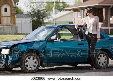 woman standing by her car after an accident View Large Photo Image Stock Photograph - woman standing by her car after an accident. Fotosearch