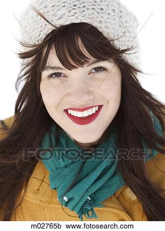 Stock Image - woman standing in the snow. Fotosearch