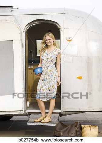 woman standing outside her airstream classic trailer View Large Photo Image Stock Image - woman standing outside her airstream classic trailer. Fotosearch